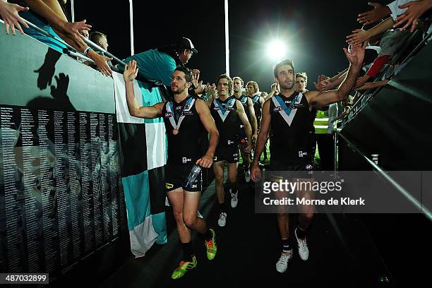Power players celebrate after the round six AFL match between Port Adelaide Power and the Geelong Cats at Adelaide Oval on April 27, 2014 in...