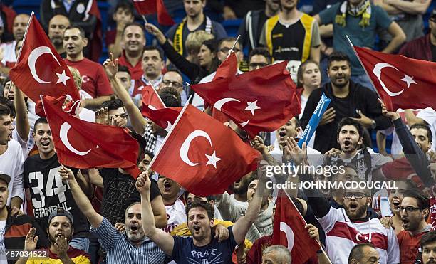 Supporters of the Turkish national team celebrate during the EuroBasket group B match Italy vs Turkey in Berlin on September 5, 2015. Turkey defeated...