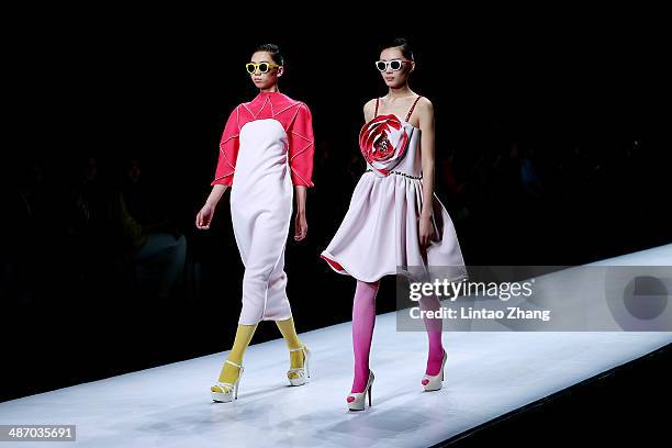 Models walk the runway wearing designs the by Beijing Union University show during the 2014 China Graduate Fashion Week at the 751D-PARK Work shop on...