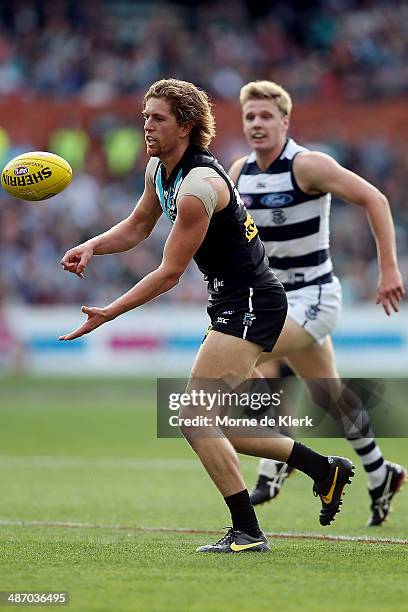 Aaron Young of the Power passes the ball during the round six AFL match between Port Adelaide Power and the Geelong Cats at Adelaide Oval on April...