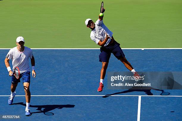 Colin Fleming of Great Britain and Treat Huey of the Philippines return a shot against Sam Groth and Lleyton Hewitt of Australia during their Men's...