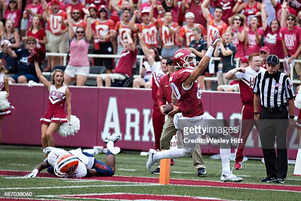 Drew Morgan of the Arkansas Razorbacks signals to the crowd after catching a pass for a touchdown during a game against the UTEP Miners at Donald W....