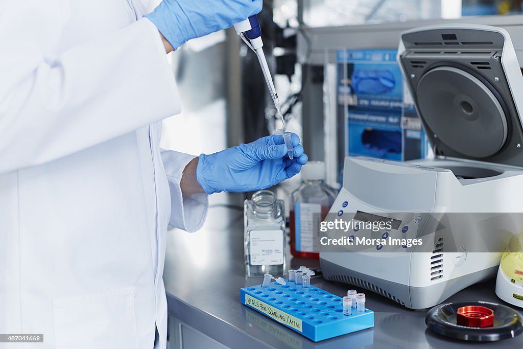 Scientist pipetting samples into eppendorf tubes
