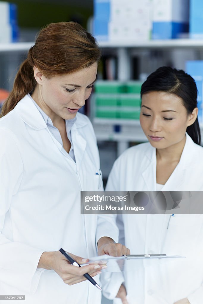 Female scientist discussing data