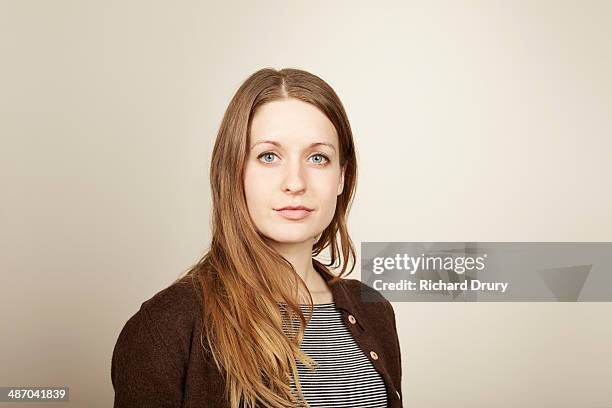 portrait of young woman looking to camera - studio head shot serious confident looking at camera foto e immagini stock