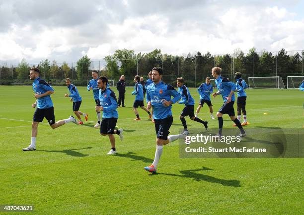 Carl Jenkinson, Santi Cazorla and Mikel Arteta of Arsenal during a training session at London Colney on April 27, 2014 in St Albans, England.