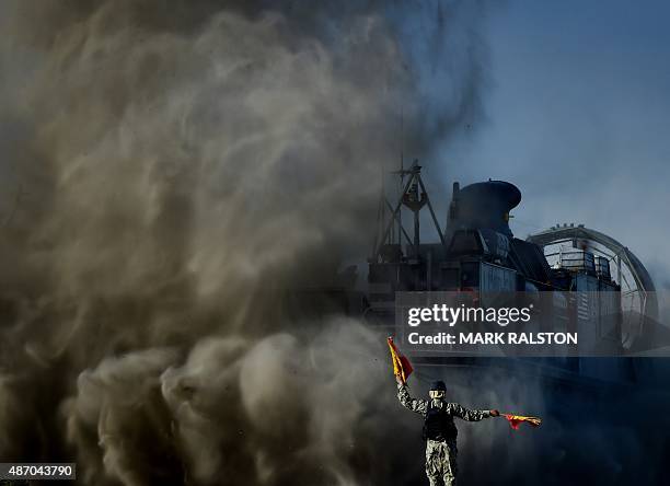 Signalman directs a US Marines Landing Craft Air Cushion hovercraft during an amphibious landing operation with the Japan Maritime Self-Defense Force...