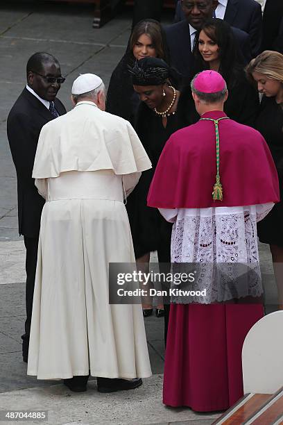 Pope Francis salutes Zimbabwe's President Robert Mugabe and his wife Grace after the canonisation in which John Paul II and John XXIII were declared...