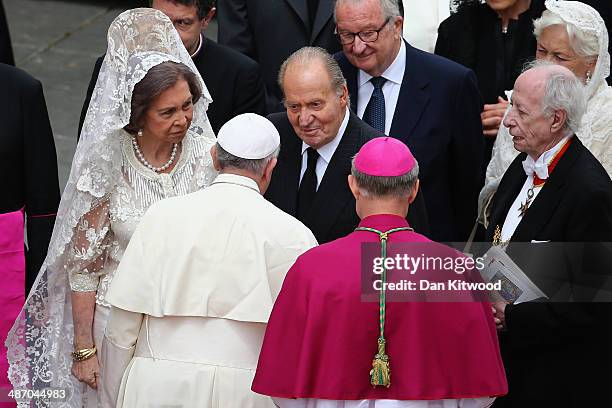 Pope Francis greets King Juan Carlos and Queen Sofia of Spain followed by King Albert II and Queen Paola of Belgium after the canonisation in which...
