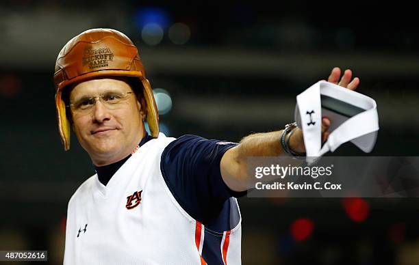 Head coach Gus Malzahn of the Auburn Tigers wears the old leather helmet trophy as he celebrates their 31-24 win over the Louisville Cardinals at...