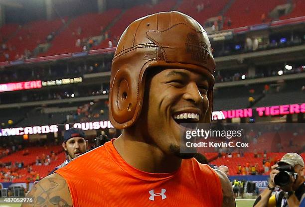 Tray Matthews of the Auburn Tigers wears the old leather helmet trophy as he celebrates their 31-24 win over the Louisville Cardinals at Georgia Dome...