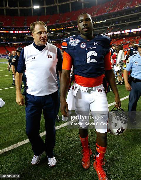Head coach Gus Malzahn and Jeremy Johnson of the Auburn Tigers celebrate their 31-24 win over the Louisville Cardinals at Georgia Dome on September...