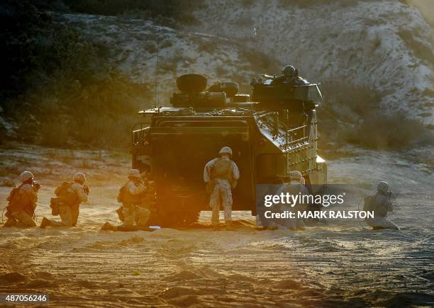 Marines take their positions during an amphibious landing operation with the Japan Maritime Self-Defense Force at the Dawn Blitz 2015 exercise in...