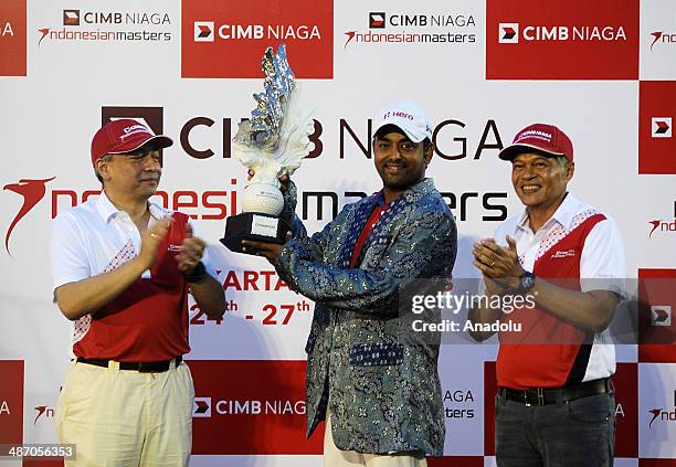 Anirban Lahiri of India poses with his trophy after winning the CIMB Niaga Indonesian Masters at Royale Jakarta Golf Club on April 27, 2014 in...