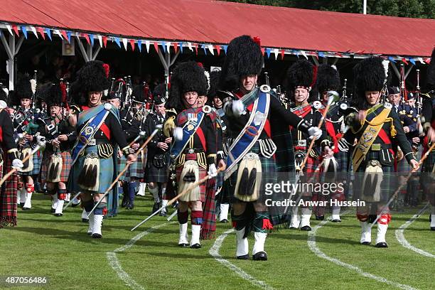 Piped bands take part in the Braemar Highland Games on September 05, 2015 in Braemar, Scotland. There has been an annual gathering at Braemar, in the...