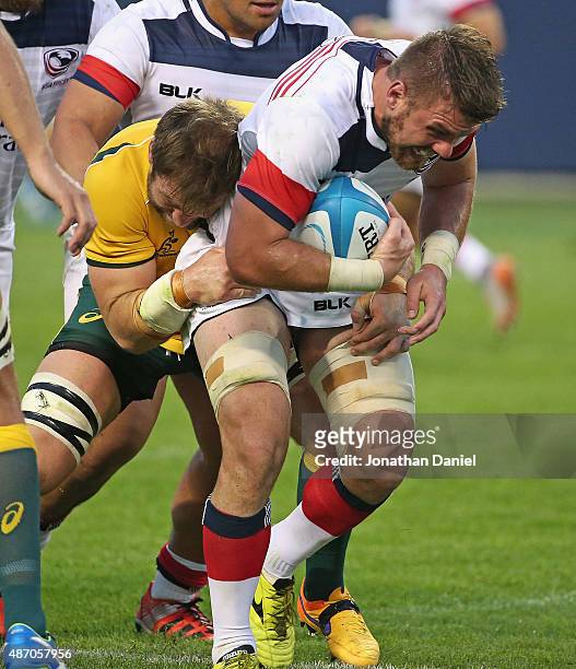 Al McFarland of the United States Eagles is tackled by Ben McCalman of the Australia Wallabies during a match at Soldier Field on September 5, 2015...