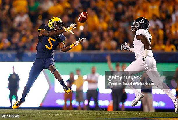 Jovon Durante of the West Virginia Mountaineers catches a pass in front of Dravon Askew-Henry of the Georgia Southern Eagles in the first half during...