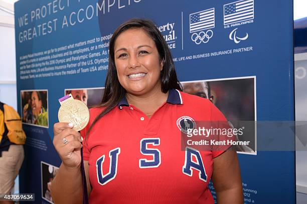 Time Olympic Water Polo player Brenda Villa shows off her London Olympic Gold medal inside the Liberty Mutual tent at the USOC Road To Rio Tour on...