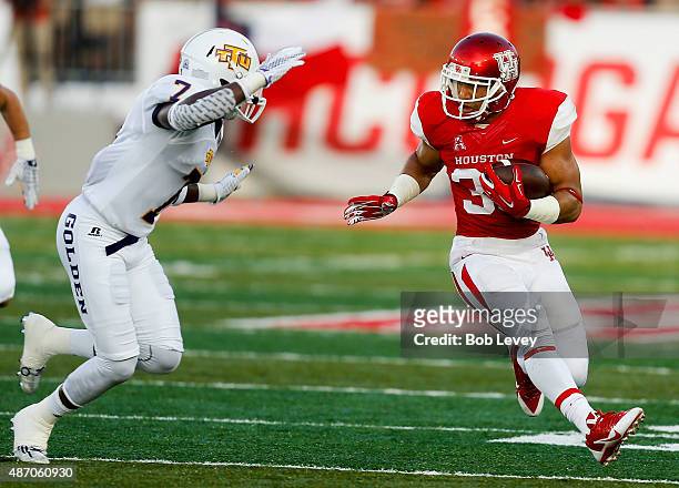 Kenneth Farrow of the Houston Cougars avoids the tackle attempt by Bill Dillard of the Tennessee Tech Golden Eagles during the game at TDECU Stadium...