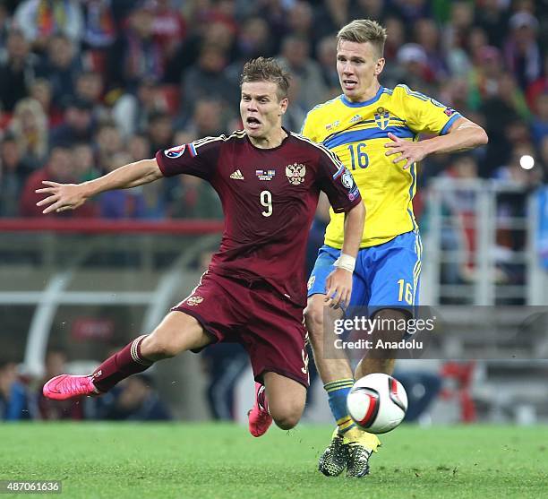 Aleksandr Kokorin of Russia vies with Pontus Wernbloom of Sweden during the UEFA Euro 2016 qualifying round Group G football match at Otkritie...