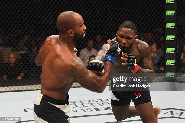 Anthony Johnson punches Jimi Manuwa in their light heavyweight bout during the UFC 191 event inside MGM Grand Garden Arena on September 5, 2015 in...