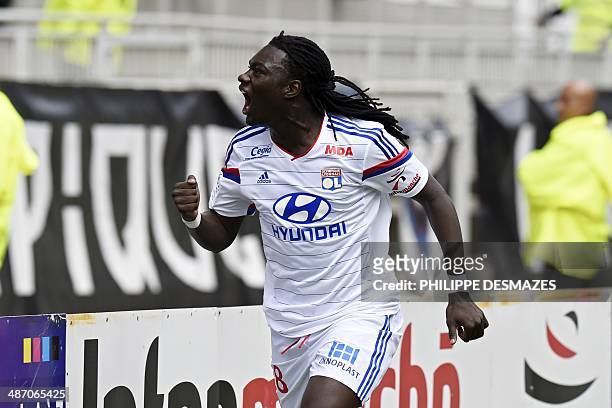 Lyon's French forward Bafetimbi Gomis reacts after opening the score during the French Ligue 1 football match between Olympique Lyonnais and SC...