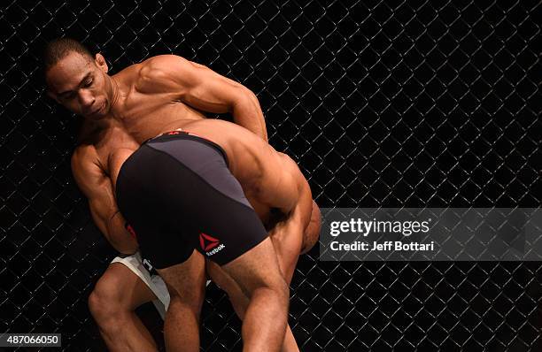 John Dodson wrestles with Demetrious Johnson in their flyweight championship bout during the UFC 191 event inside MGM Grand Garden Arena on September...