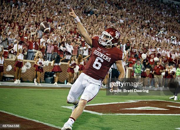 Quarterback Baker Mayfield of the Oklahoma Sooners celebrates a touchdown against the Akron Zips September 5, 2015 at Gaylord Family-Oklahoma...
