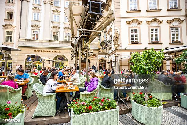 people relaxing in prague cafe - prague cafe stock pictures, royalty-free photos & images