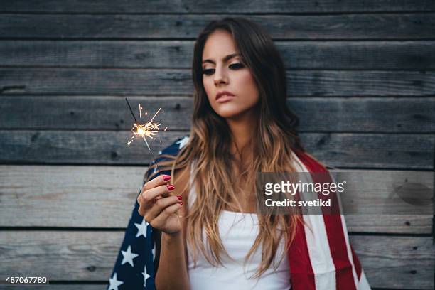 young woman with american flag. - american flag fireworks stockfoto's en -beelden
