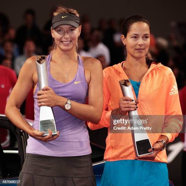 Maria Sharapova of Russia and Ana Ivanovic of Serbia pose with their trophys after the final against on day seven of the Porsche Tennis Grand Prix...