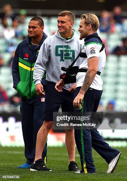 Suspended Raiders players Jack Wighton and Joseph Leilua stand with injured team mate Blake Austin during the round 26 NRL match between the...