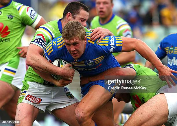 Daniel Alvaro of the Eels is tackled by Shaun Fensom of the Raiders during the round 26 NRL match between the Parramatta Eels and the Canberra...