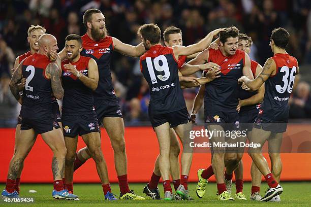 Demons players celebrates a goal by Jesse Hogan during the round 23 AFL match between the Melbourne Demons and the Greater Western Sydney Giants at...