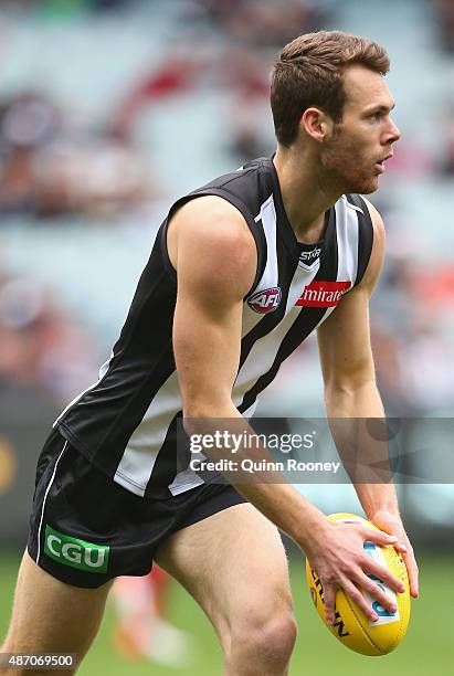 Matt Scharenberg of the Magpies kicks during the round 23 AFL match between the Collingwood Magpies and the Essendon Bombers at Melbourne Cricket...