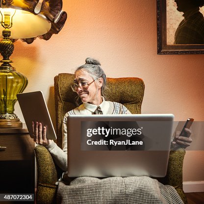 Grandma Using Multiple Modern Electronics Grandma Using Multiple Modern Electronics