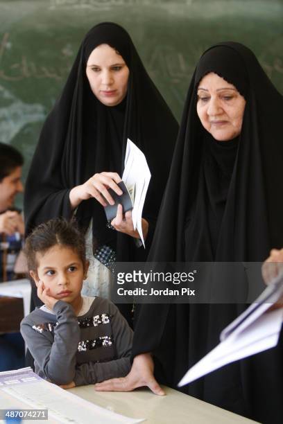 Two women vote in the Iraqi parliamentary elections at a polling station April 27, 2014 in Amman, Jordan. Iraq's former prime minister Ayad Allawi on...