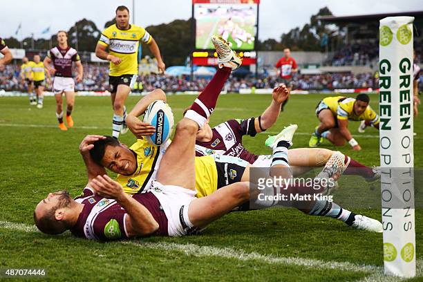 Sosaia Feki of the Sharks is held up in the corner by Brett Stewart of the Sea Eagles during the round 26 NRL match between the Cronulla Sharks and...