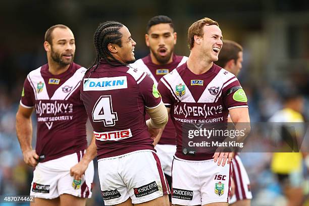 Steve Matai of the Sea Eagles laughs with Daly Cherry-Evans after he dropped the ball after an intercept during the round 26 NRL match between the...