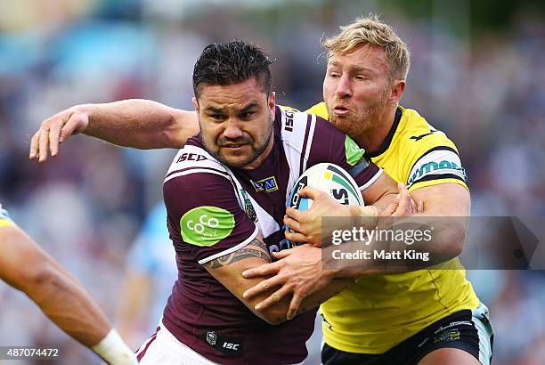 Justin Horo of the Sea Eagles is tackled by Matt Prior of the Sharks during the round 26 NRL match between the Cronulla Sharks and the Manly Sea...