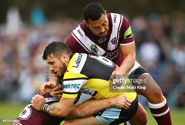 Jack Bird of the Sharks is tackled by Feleti Mateo of the Sea Eagles during the round 26 NRL match between the Cronulla Sharks and the Manly Sea...