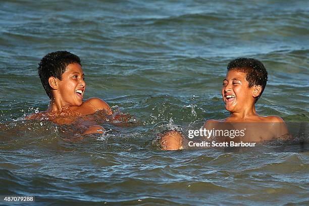 Two Samoan children swim in the ocean during the preview day of the Vth Commonwealth Youth Games on September 6, 2015 in Apia, Samoa.