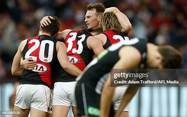 Brendon Goddard of the Bombers celebrates with teammates on the siren during the 2015 AFL round 23 match between the Collingwood Magpies and the...