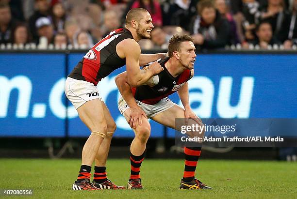 Heath Hocking and David Zaharakis of the Bombers watch as the winning goal goes through during the 2015 AFL round 23 match between the Collingwood...