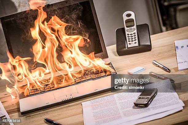 close up view of burning laptop - business humor stock pictures, royalty-free photos & images