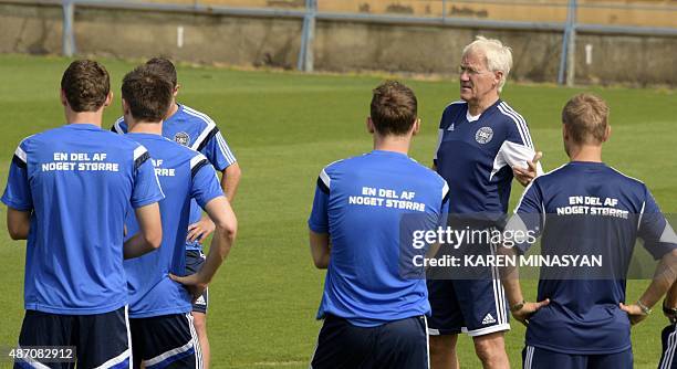 Denmark's coach Morten Olsen talks to players during a practice session in Yerevan on September 6 a day ahead of the UEFA Euro-2016 qualifying round...