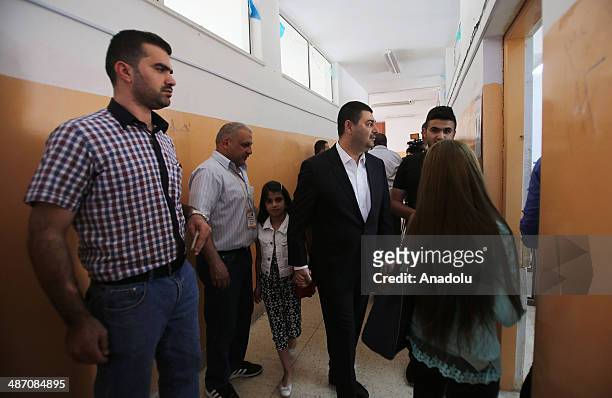 Iraqis living in Jordan capital Amman, wait in queue to cast their ballots in the Iraqi parliamentary elections at the polling station in Amman,...