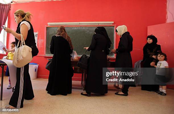 Iraqis living in Jordan capital Amman, wait in queue to cast their ballots in the Iraqi parliamentary elections at the polling station in Amman,...