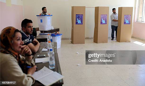 Iraqis living in Jordan capital Amman, wait in queue to cast their ballots in the Iraqi parliamentary elections at the polling station in Amman,...