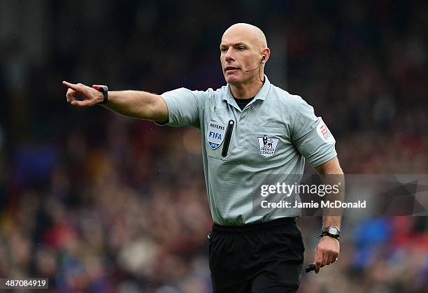 Referee Howard Webb makes his point during the Barclays Premier League match between Crystal Palace and Manchester City at Selhurst Park on April 27,...